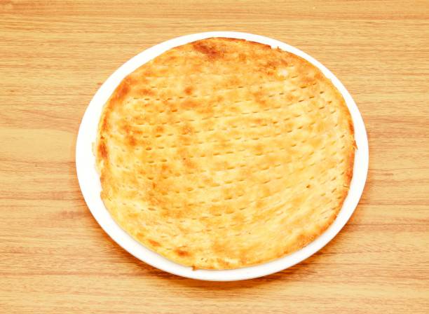 sheermal taftan, naan or kulcha, roti served in a dish isolated on wooden table side view of indian, pakistani food sheermal taftan, naan or kulcha, roti served in a dish isolated on wooden table side view of indian, pakistani food taftan stock pictures, royalty-free photos & images