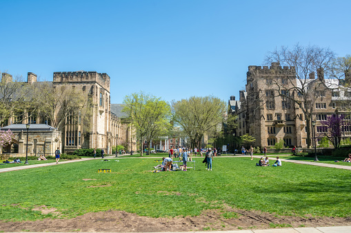 New Haven, Connecticut, United States of America - April 28, 2017. Courtyard in the Cross Campus of Yale University in New Haven, CT. View towards Bass Library, William L. Harkness Hall and Hopper College. View with people on a sunny day.