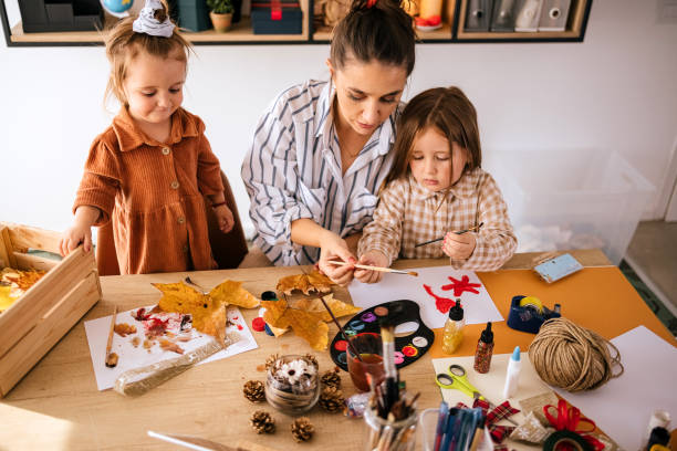 istock Young mother painting with kids 1435839667