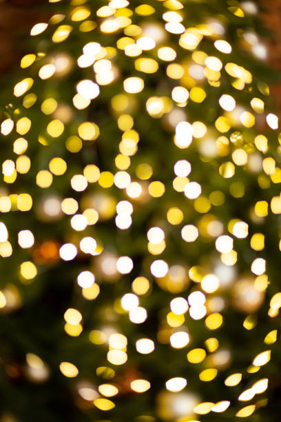 istock Christmas  tree and festive bokeh lighting, blurred holiday background 1435842938