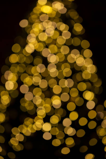 istock Christmas tree festive bokeh lighting, blurred holiday background 1435842962
