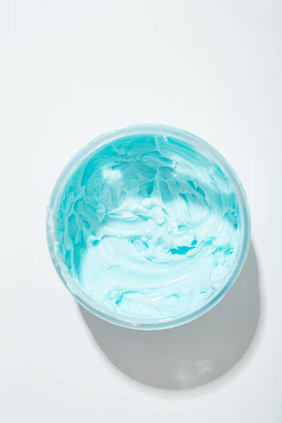 istock Top view of blue cream boby sutter in jar cometic products on light surface 1435842967