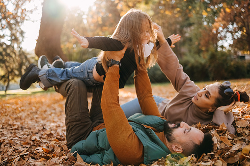 Young family enjoying a beautiful autumn day in nature