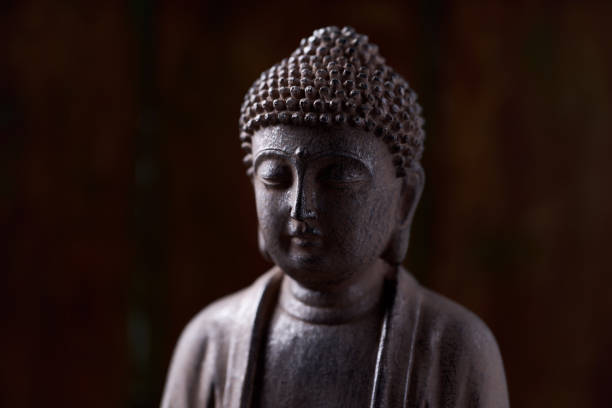 istock Meditating Buddha Statue on dark background. Soft focus. Close up. Copy space. 1435854758