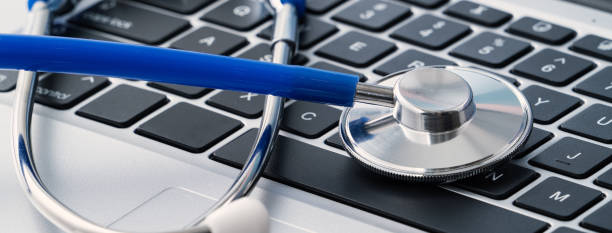 istock Blue stethoscope on laptop computer keyboard, medical design concept. 1435855679