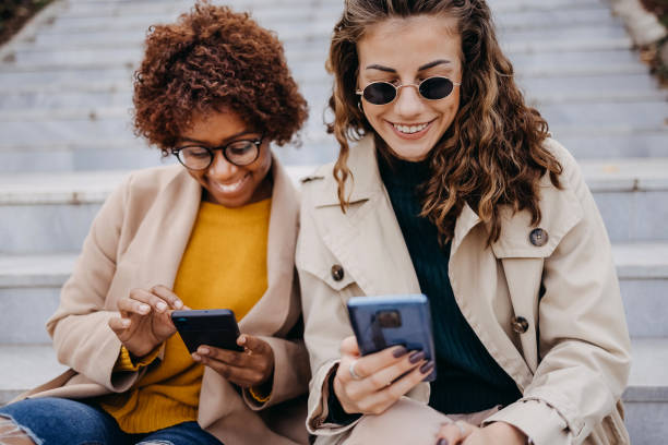 istock Young beautiful women using smart phone 1435859879