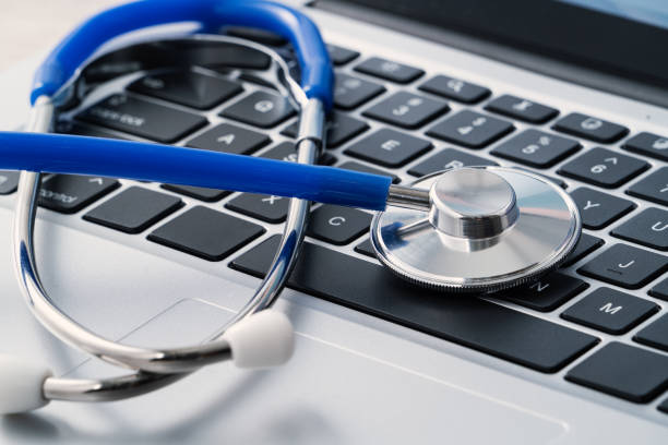 istock Blue stethoscope on laptop computer keyboard, medical design concept. 1435860064