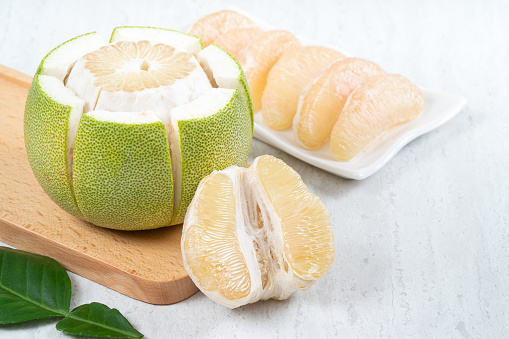 Close up of fresh peeled pomelo on white table background for Mid-Autumn Festival fruit.