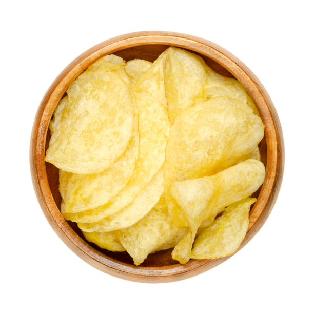 istock Salted potato chips, crisps, deep fried potato slices in a wooden bowl 1435865415