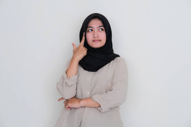 istock Asian young girl wearing hijab looking above while thinking about something 1435865808