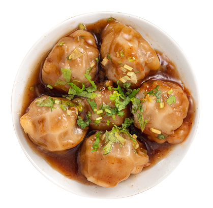 Bawan (Ba wan), Taiwanese meatball delicacy, delicious street food, steamed starch wrapped round shaped dumpling with pork and shrimp inside and thick soy sauce isolated on white bakcground.