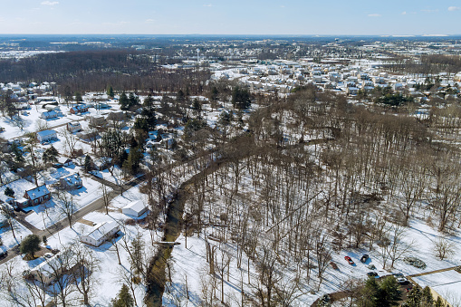 It is small American town in Pennsylvania where residential complex has snowy roof after severe snowstorm has hit the area