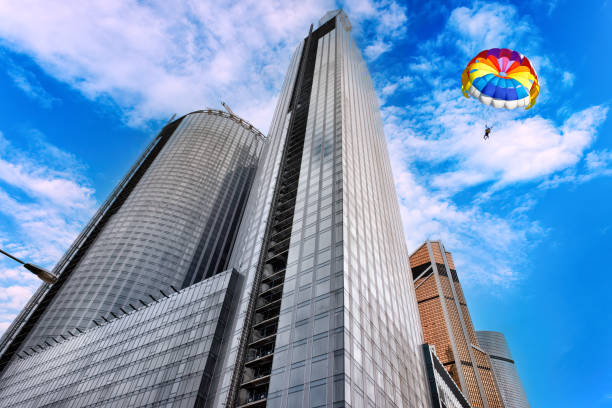 Beautiful high skyscrapers and parachute against the backdrop of a bright blue sky.