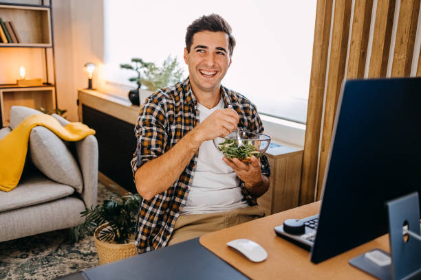 Having snack while working from home stock photo