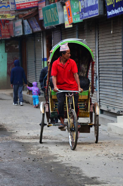 Classic antique vintage retro rickshaw trishaw bicycle for nepali people foreign travelers passenger use service journey in bazaar market old town at thamel city in Kathmandu Nepal stock photo