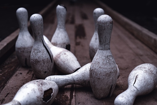 A closeup of dirty broken bowling pins outdoors at Pavliani park in Greece