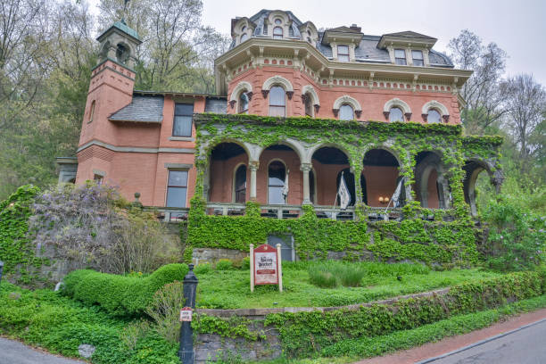 Jim Thorpe, Pennsylvania, United States of America - May 1, 2017. The Harry Packer Mansion in Jim Thorpe, PA. The mansion was designed by architect Addison Hutton and built in 1874. It is a 2+12-story, three-bay-wide, red-brick dwelling in the Italianate style. The front facade features a verandah constructed of green Vermont sandstone and a bell tower attached to the two-story extension. It was given as a wedding gift to Harry Packer from his father Asa Packer. It is located in the Old Mauch Chunk Historic District.