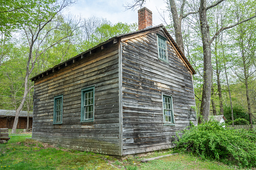 Hardwick, New Jersey, United States of America - May 1, 2017. Spangenberg Cabin at Millbrook village in Delaware Water Gap, NJ. The log cabin adjacent to the parking lot was erected by Lester Spangenberg. He dismanted a log barn and used the materials to construct this residence. It is one of the few log cabins remaining in the area.