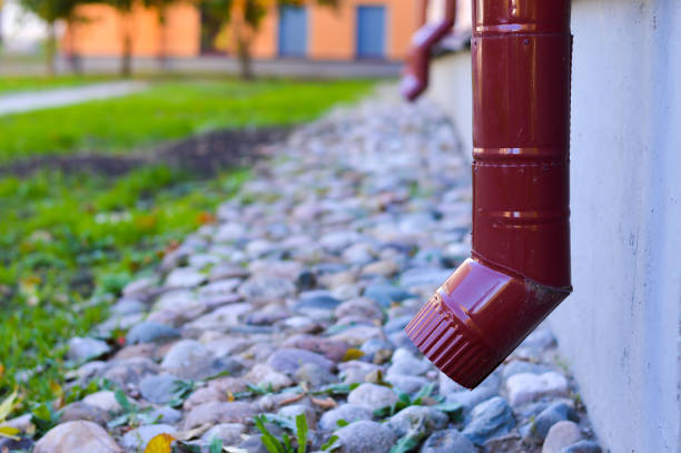 Rain flowing into a storm water sewer system. Stormwater street drain during heavy rain.