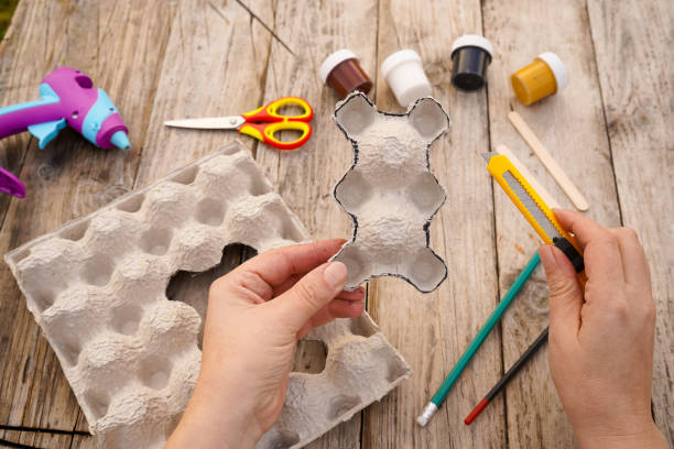 istock Step by step diy process. Step 3- we cut out a teddy bear figurine from an egg cardboard box. Creativity, crafting. Zero waste concept. 1435874587
