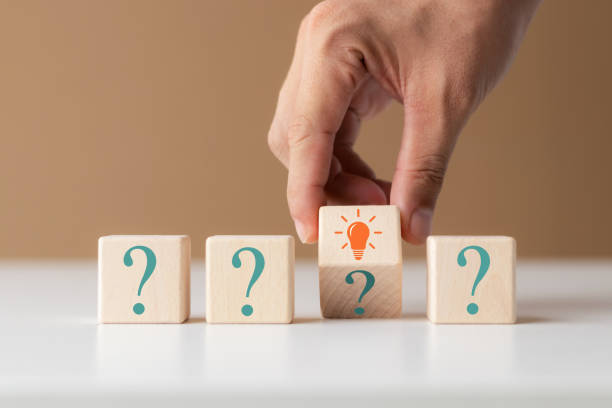 istock Creative concept. Think different, wooden cube with question mark and light bulb sign. 1435874807