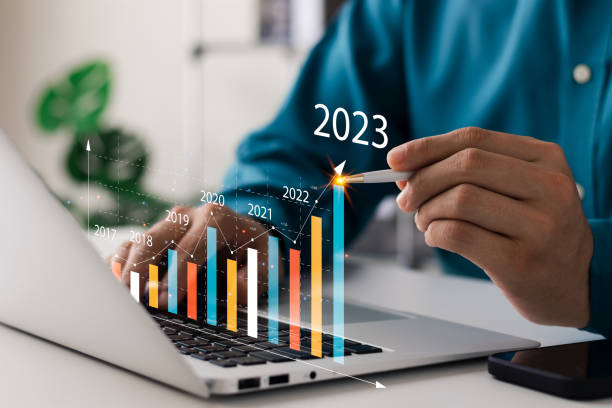 Businessman analyzes profitability of working companies with digital augmented reality graphics, positive indicators in 2023, businessman calculates financial data for long-term investments. stock photo