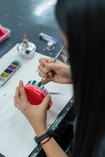 istock Hands of a dentistry student working in class with her work implements 1435875558