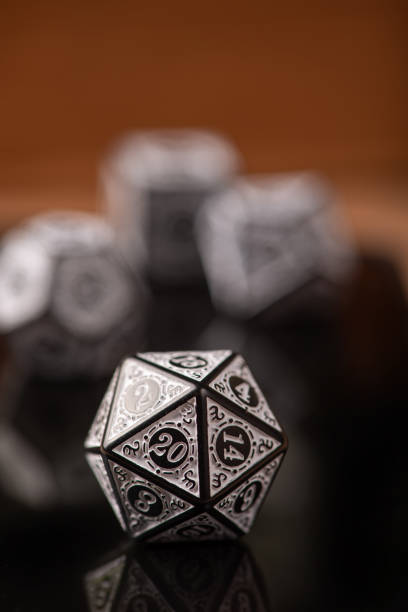 istock RPG dice, beautiful RPG game dice in detail on reflective surface, selective focus. 1435876817