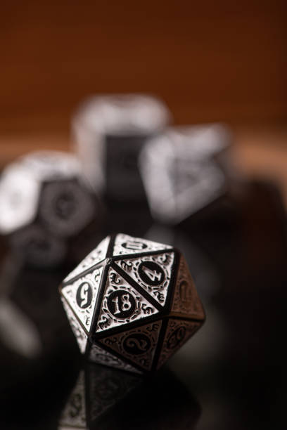istock RPG dice, beautiful RPG game dice in detail on reflective surface, selective focus. 1435876828