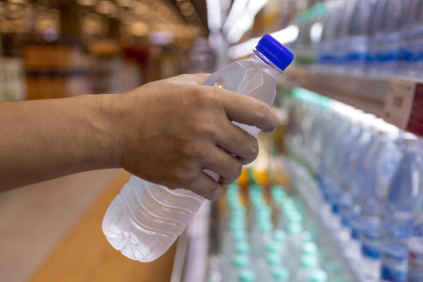 istock Man buying bottled water in grocery store 1435876884