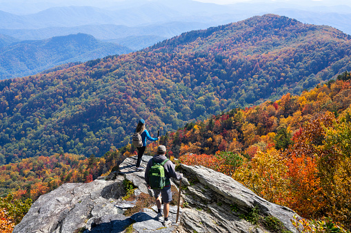 Friends on top of the mountain enjoying beautiful autumn scenery. Blue Ridge Mountains, near Asheville, North Carolina, USA