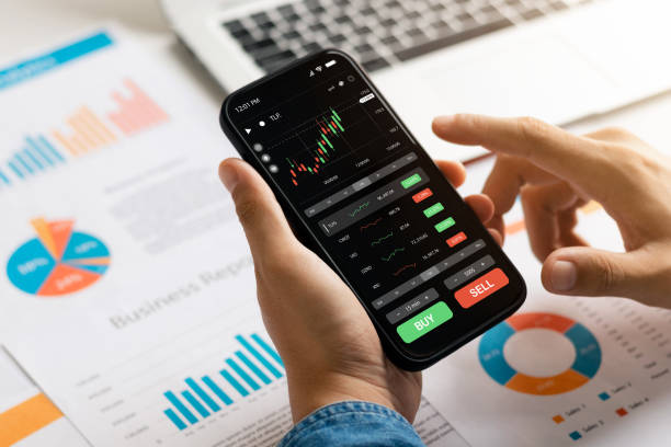 istock Businessmen work with stock market investments using smartphone to analyze trading data. smartphone with stock exchange graph on screen. Financial stock market. 1435879074