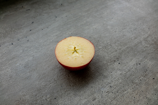Half apple on a concrete background