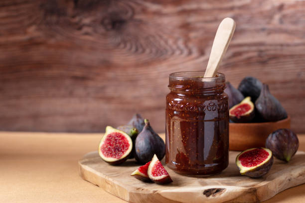 istock Fig jam or fig marmalade on wooden board with fresh, ripe figs 1435885503