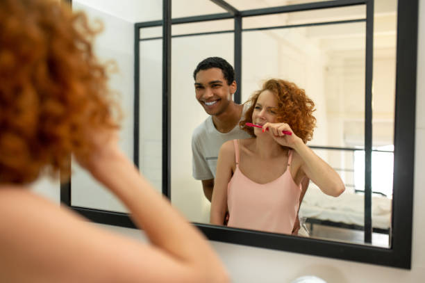 istock Two young people having morning procedures together and brushing teeth 1435885971