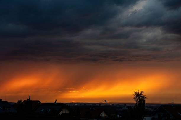 istock Beautiful bright orange stormy sunset sky over a field 1435887071
