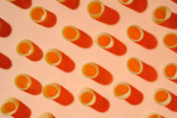 istock raw pasta on a bright yellow background. Food pattern 1435887723