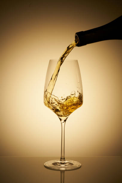 istock Pouring glass of white wine with copy space 1435887735