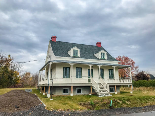 Nice big country house during day of autumn with dormers, large balcony.