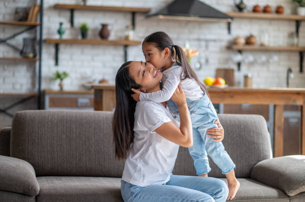 istock Affectionate daughter kissing her mother on the cheek 1435893028