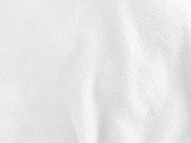 istock White clean wool texture background. light natural sheep wool. white seamless cotton. texture of fluffy fur for designers. close-up fragment white wool carpet. 1435893119