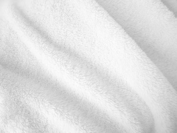 istock White clean wool texture background. light natural sheep wool. white seamless cotton. texture of fluffy fur for designers. close-up fragment white wool carpet. 1435893190