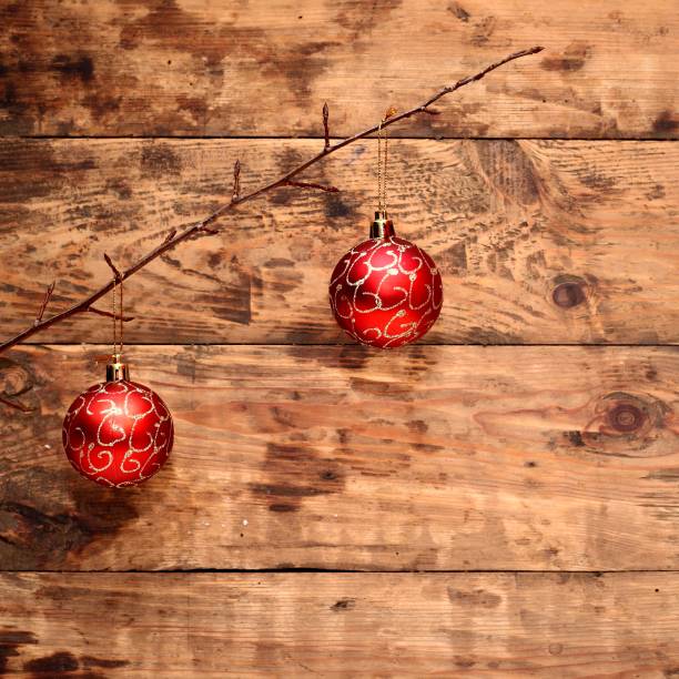 istock Two red baubles on wooden background. 1435893461