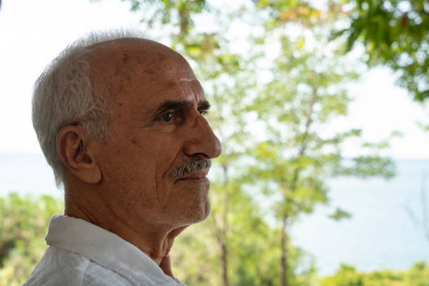 istock Senior man relaxing at park bench 1435893464