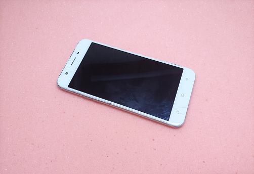 White smartphone with cracked screen