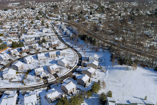An American small town in New Jersey where many homes have snow covering their roofs after severe snow storm hit the area