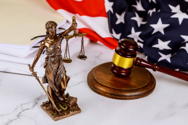 istock A statue of justice in front of a gavel with administration documents folders standing on a lawyer's desk is depicted by the law 1435898054