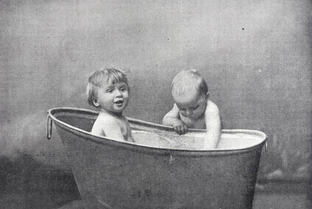 istock Two children in and around the bathtub having fun 1435899438
