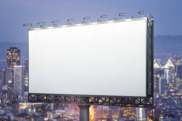 Blank white horizontal billboard on skyline background at evening, perspective view. Mock up, advertising concept stock photo