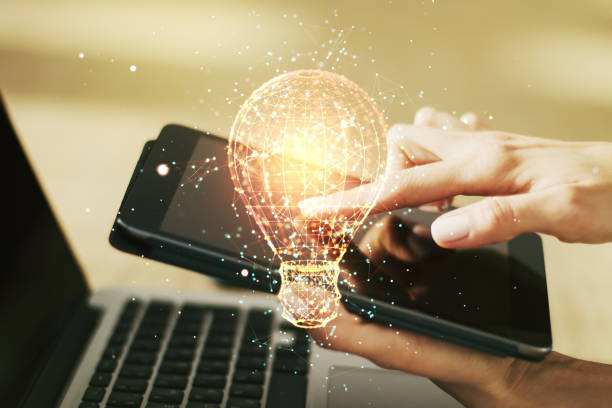 istock Creative idea concept with light bulb illustration and finger clicks on a digital tablet on background. Multiexposure 1435900025